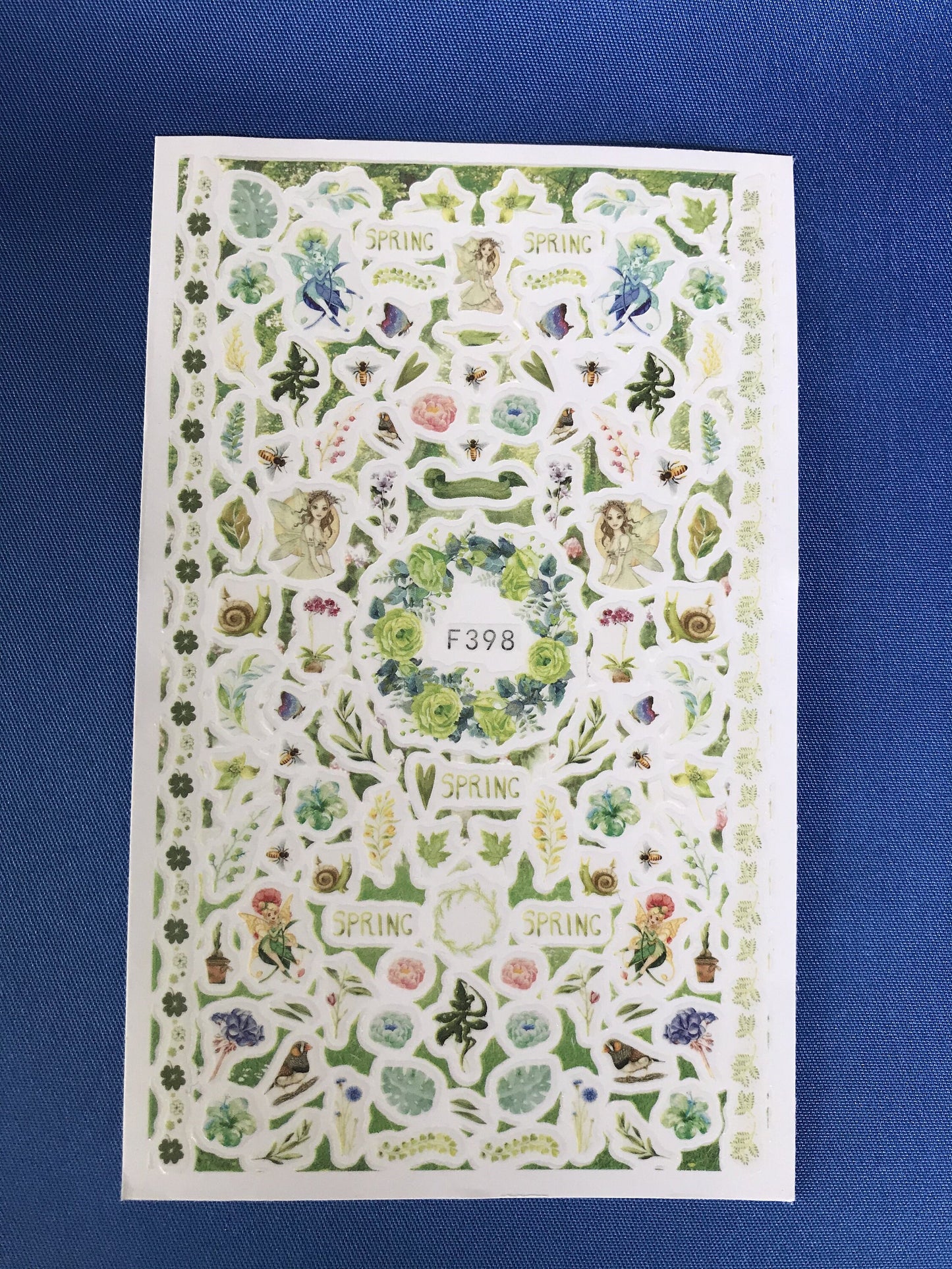 Think spring nail art stickers showing fairys birds snail flowers greens